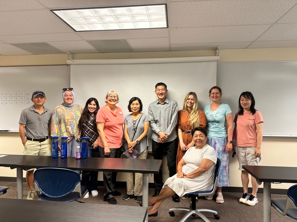 Lee-Ann (4th from left in a peach-colored shirt) stands with the students from the ESL program who participated in the Southlake Writing Center's first GameDay.  